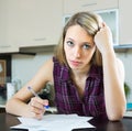 Serious woman with documents in kitchen Royalty Free Stock Photo