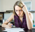 Serious woman with documents in kitchen Royalty Free Stock Photo