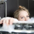 Serious woman enjoys the bath-foam in the bathtub. Royalty Free Stock Photo