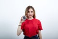 Serious woman in fashion red shirt having compas, looking at camera