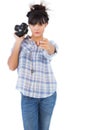 Serious woman holding camera and pointing her finger Royalty Free Stock Photo