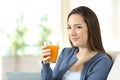 Serious woman holding a glass of orange juice Royalty Free Stock Photo