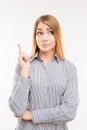 Serious woman pointing up on background Royalty Free Stock Photo