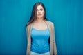 Serious woman portrait on blue. Royalty Free Stock Photo