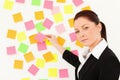 Serious woman putting repositionable notes Royalty Free Stock Photo