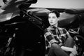 Serious woman in a shirt on a motorcycle background, smoothed hair, black and white Royalty Free Stock Photo