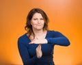 Serious woman showing time out gesture with hands