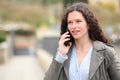 Serious woman talking on cell phone in the street Royalty Free Stock Photo