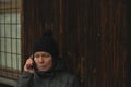 Serious woman talking on mobile phone on street in winter Royalty Free Stock Photo