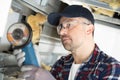 serious workman using angle grinder