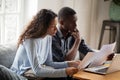 Serious worried african american couple reading documents at hom Royalty Free Stock Photo