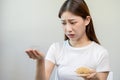 Serious, worried asian young woman, girl holding comb, show her hairbrush with long loss hair problem after brushing, hair fall Royalty Free Stock Photo