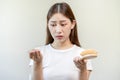 Serious, worried asian young woman, girl holding comb, show her hairbrush with long loss hair problem after brushing, hair fall Royalty Free Stock Photo