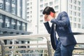 Serious businessman talking on red cell phone in the city. concept of Business failure and Sales decreased. Royalty Free Stock Photo