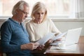 Serious worried senior couple reading documents calculating bill Royalty Free Stock Photo