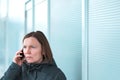 Serious worried woman talking on mobile phone on street Royalty Free Stock Photo