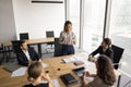 Serious young African American professional woman talking to business partners Royalty Free Stock Photo