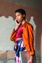 Serious Young African American Woman talking on cell phone, walking on street in New York City Royalty Free Stock Photo