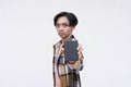 A serious young asian man holding an external HDD hard drive. Focus on face. Isolated on a white background Royalty Free Stock Photo