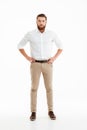 Serious young bearded man standing over white wall Royalty Free Stock Photo