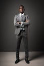 Serious young black man with glasses and gray business suit crossed his arms Royalty Free Stock Photo