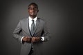 Serious young black man with glasses and gray business suit