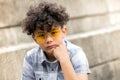 Serious young boy in yellow sunglasses Royalty Free Stock Photo