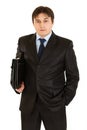 Serious young businessman with briefcase in hand Royalty Free Stock Photo