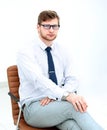 Serious young businessman sitting in office chair. Royalty Free Stock Photo