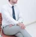 Serious young businessman sitting in office chair. Royalty Free Stock Photo