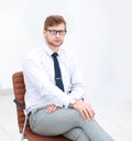 Serious young businessman sitting in office chair. Royalty Free Stock Photo