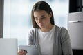 Serious young businesswoman looking at computer tablet screen in office Royalty Free Stock Photo