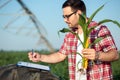 Young agronomist or farmer filling questionnaire in corn field Royalty Free Stock Photo