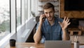 Young Caucasian businessman work on laptop talk on smartphone Royalty Free Stock Photo