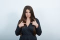 Serious young caucasian lady pointing fingers at herself over  gray wall Royalty Free Stock Photo