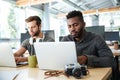 Serious young colleagues sitting in office coworking Royalty Free Stock Photo