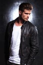 Serious young fashion model in leather jacket