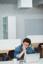 Serious young guy with beard working on laptop Royalty Free Stock Photo