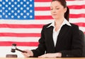 Serious young judge knocking a gavel Royalty Free Stock Photo