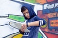 Serious young man boy in blue hoody sweater checking syncing pad with smart watch Royalty Free Stock Photo