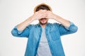 Serious young man covered his eyes by hands Royalty Free Stock Photo