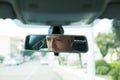 Serious young man driver reflection in rear view mirror isolated interior car windshield Royalty Free Stock Photo