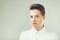 Serious young man with short hair, shaved beard, trace of acne Royalty Free Stock Photo