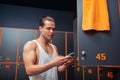 Serious young man standing in the changing room Royalty Free Stock Photo