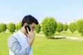 Serious young man talking on mobile phone. Royalty Free Stock Photo