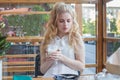 Serious young woman with an aromatic coffee in her hands Royalty Free Stock Photo