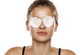 Serious young woman with cotton pads over her eyes Royalty Free Stock Photo