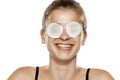 Serious young woman with cotton pads over her eyes Royalty Free Stock Photo