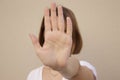 Serious young woman showing stop hand sign, on isolated background Royalty Free Stock Photo