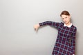 Serious young woman is showing thumb down gesture of disapproval Royalty Free Stock Photo